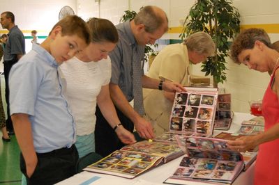 Sunday Party at OLS School
Photo albums.  Andrew, Ginger, and Garret Smith check out the albums along with Louisa Matula and Peg Higham
