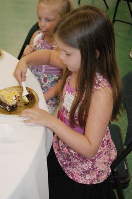 Sunday Party at OLS School
Cake: Julia Higham tastes her cake.
