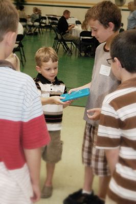 Sunday Party at OLS School
Games: Tyler Entwistle hands gift to Sam Hughes.
