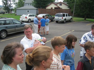 Saturday Church 3
Church 3:  Family members watch Jan open gift.
