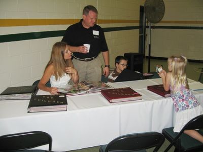 Sunday Party at OLS School
Photos: Cathy, John, Thomas, and Julia Higham look at family photos.
