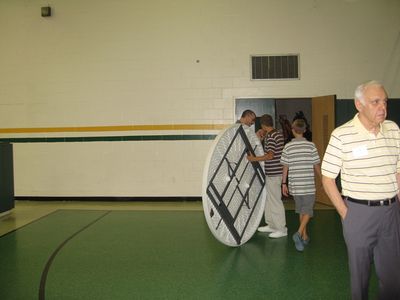 Sunday Party at OLS School
Food Clean Up: Tables Away! Arik Foley wheels `em in.  Art Glazer serves as traffic coordinator.
