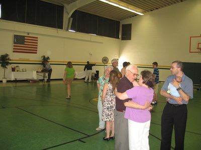 Sunday Party at OLS School
Guests: Time to say good-bye.  Harold Fanning talks to Sue Foley in foreground, Mark Glazer, holding Eli, looks on.  Background, Katie Higham talks to Great Aunt Eileen Fanning.
