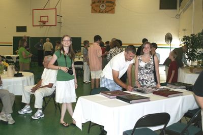 Sunday Party at OLS School
Photo albums: Rachel looks on as Andy Foley and Katie Higham view albums.
